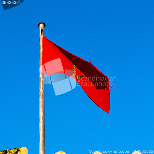 Image of tunisia  waving flag in the blue sky  colour and battlements  wa