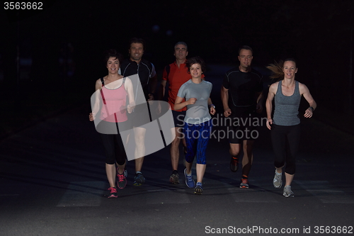 Image of people group jogging at night