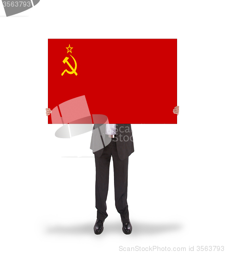 Image of Smiling businessman holding a big card, flag of the USSR