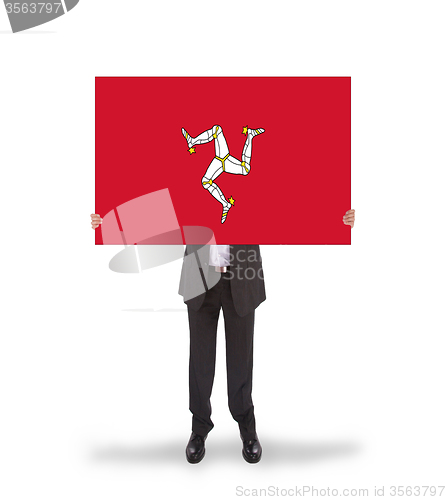 Image of Smiling businessman holding a big card, flag of Isle of Man