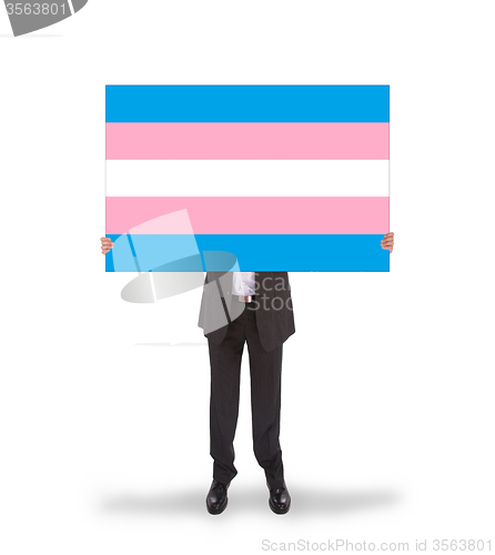 Image of Smiling businessman holding a big card, flag of Trans Pride