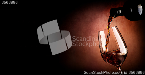 Image of Pouring wine on brown