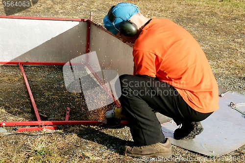 Image of Man grinding steel