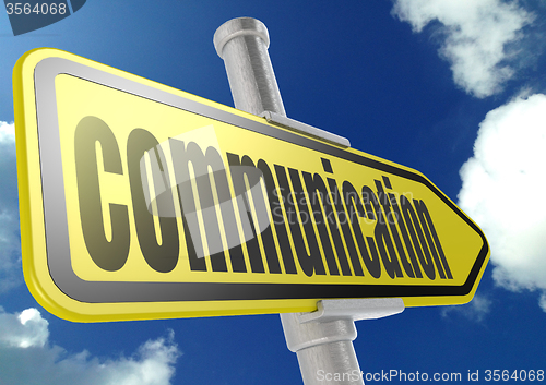 Image of Yellow road sign with communication word under blue sky