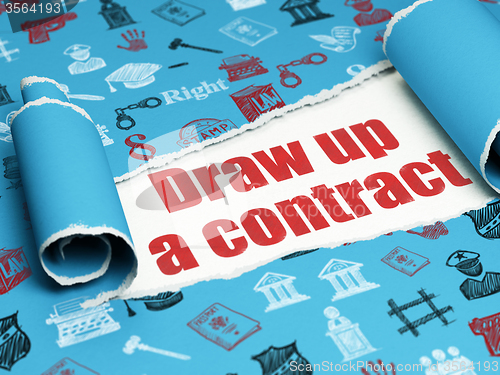 Image of Law concept: red text Draw up A contract under the piece of  torn paper