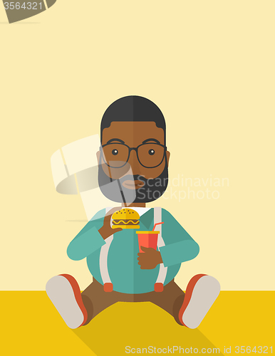 Image of Man eating hamburger. 
