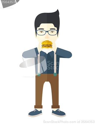 Image of Man eating hamburger. 