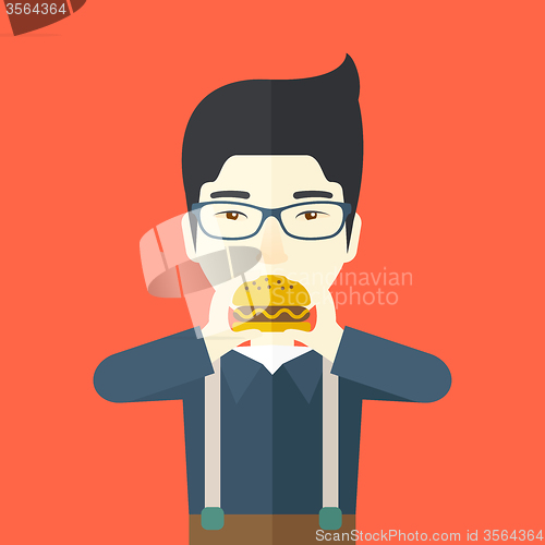 Image of Man eating hamburger. 