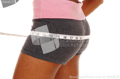 Image of Girl measuring her butt, body part.