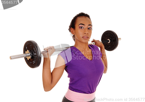 Image of African american woman weight lifting.