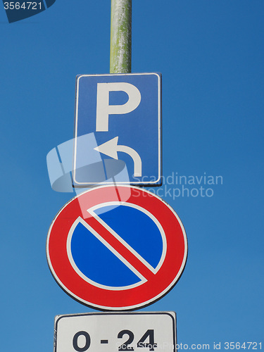 Image of No parking sign over blue sky