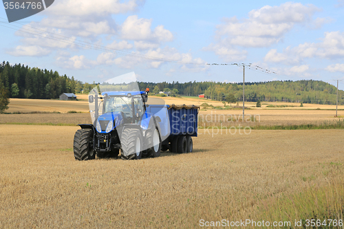 Image of New Holland Tractor and Blue Trailer Autumn Field Landscape