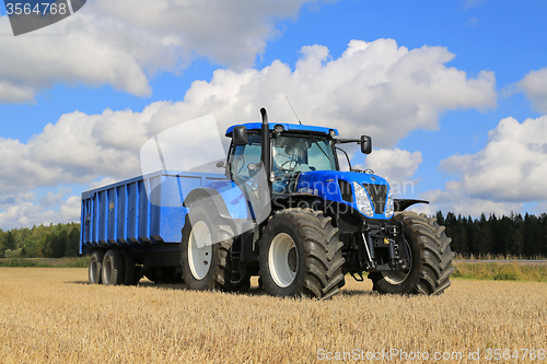 Image of New Holland T7.250 Tractor and Agricultural Trailer on Field