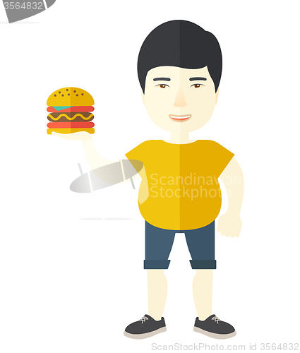 Image of Man with hamburger. 