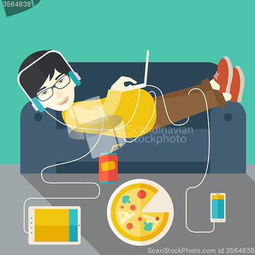 Image of Man lying on sofa.