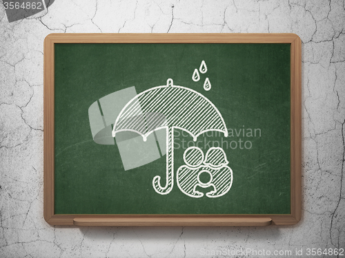 Image of Safety concept: Family And Umbrella on chalkboard background