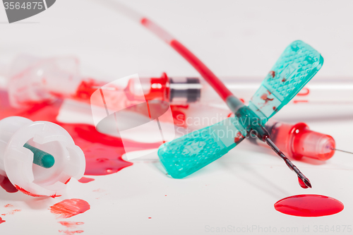 Image of Syringes and IV Lines Covered with Blood