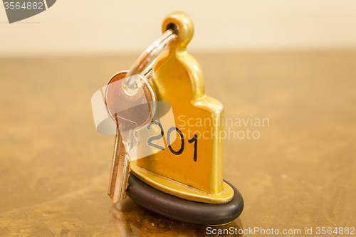 Image of Hotel Room Key lying on Bed with keyring