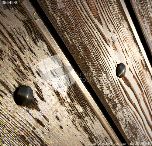 Image of cheglio  knocker in a  door curch  closed wood italy  lombardy 