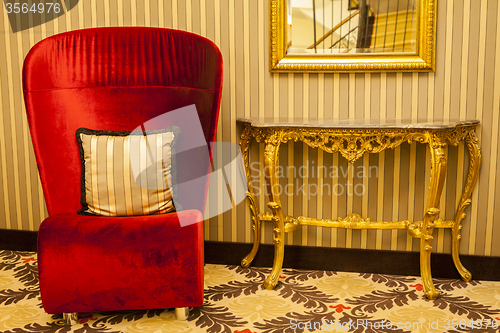 Image of Royal Armchair in red in warm athmosphere decoration