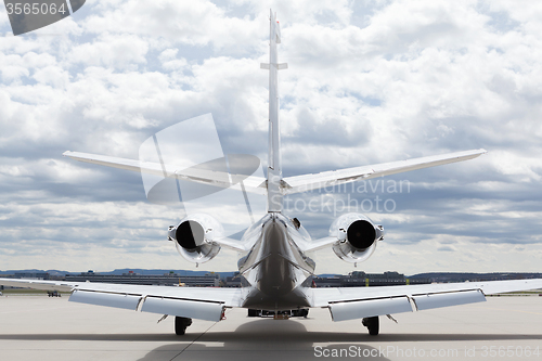 Image of Aircraft learjet Plane in front of the Airport with cloudy sky