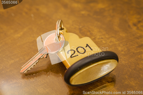 Image of Hotel Room Key lying on Bed with keyring