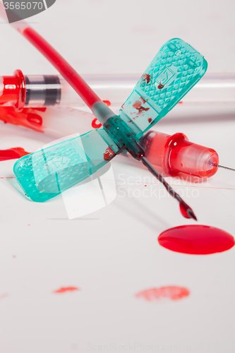 Image of Syringes and IV Lines Covered with Blood