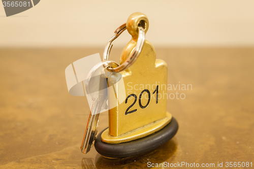 Image of Hotel Room Key lying on Bed with keyring