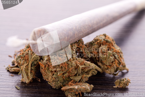 Image of Close up of dried marijuana leaves and joint