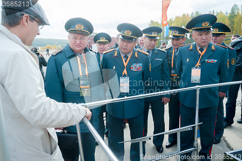 Image of Officers of Kazakh army examine troop-carrier