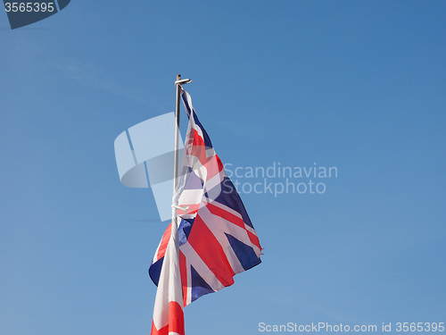 Image of Flag of UK over blue sky