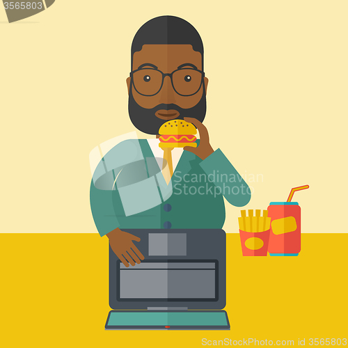 Image of Man eating hamburger. 