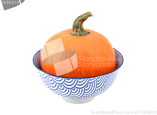 Image of Bright orange sugar pumpkin in a blue and white bowl