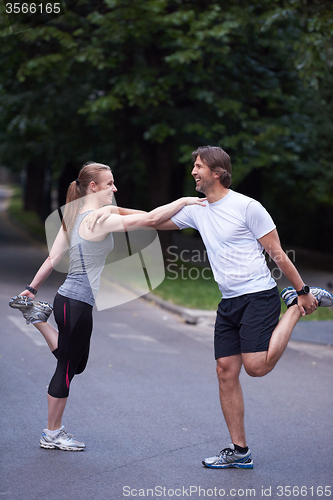 Image of jogging couple stretching