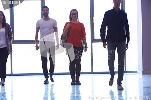 Image of student girl standing with laptop, people group passing by