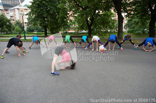 Image of jogging people group stretching