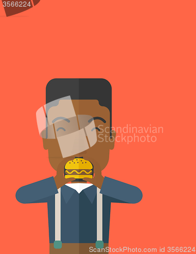 Image of Man eating hamburger. 