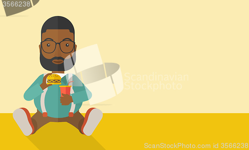 Image of Man eating hamburger. 
