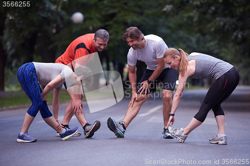 Image of jogging people group stretching