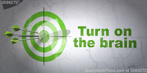 Image of Learning concept: target and Turn On The Brain on wall background