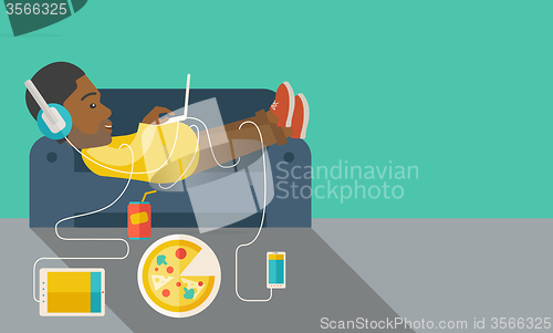 Image of Man lying on sofa.