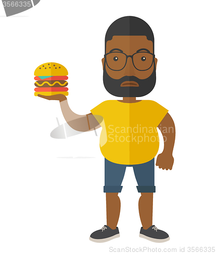 Image of Man with hamburger. 