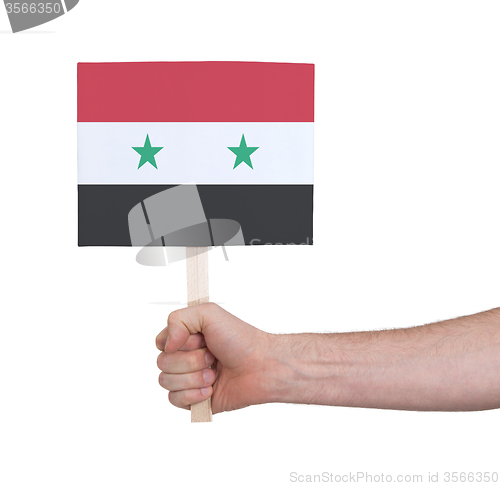 Image of Hand holding small card - Flag of Syria
