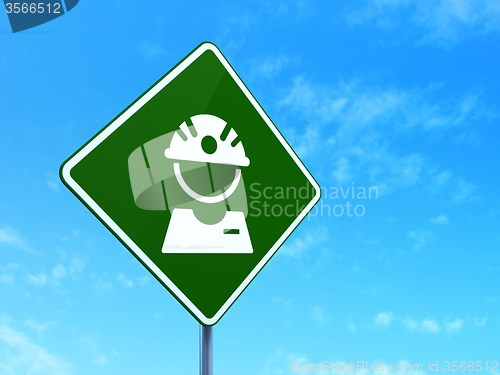 Image of Manufacuring concept: Factory Worker on road sign background