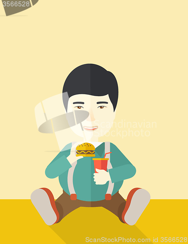 Image of Man eating hamburger. 