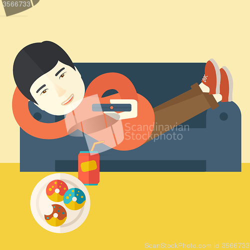 Image of Man lying on sofa.