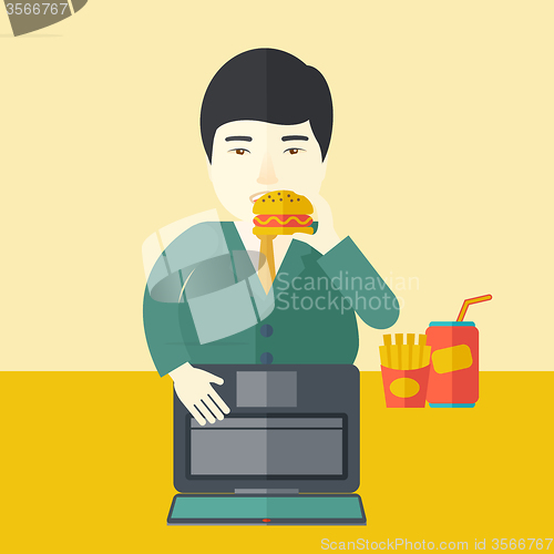Image of Man eating hamburger. 