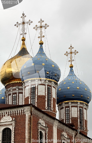 Image of cross and gold stars on the church dome