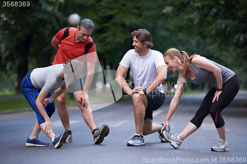 Image of jogging people group stretching