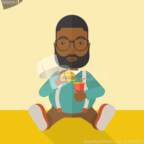 Image of Man eating hamburger. 